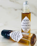 Bottle of Adia Oils Sweet Patchouli natural fragrance oil with a clear glass container and a black cap.