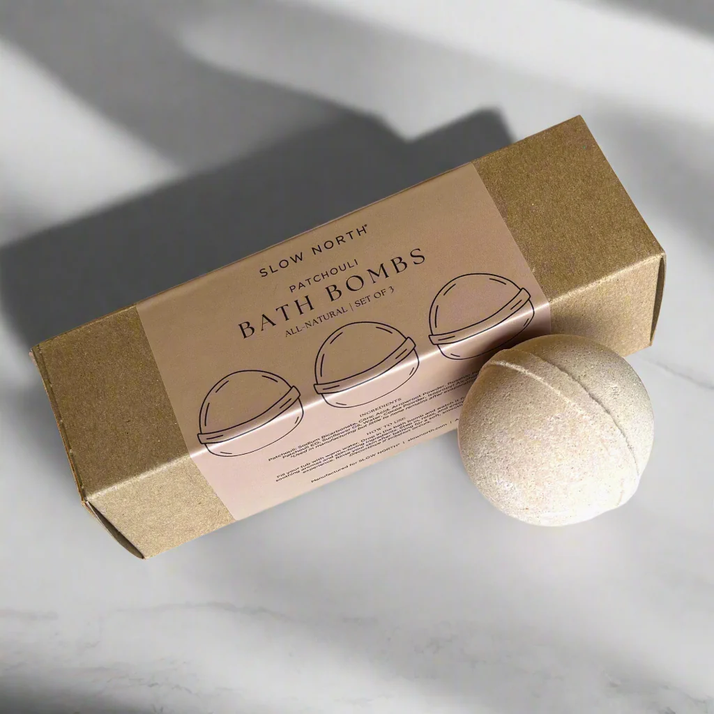 Set of three natural patchouli bath bombs by Slow North, showcasing colorful round bath accessories in a spa setting.